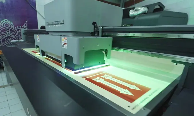 UV flatbed printer printing a rigid board