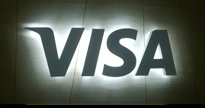 Backlit logo sign glowing on a dark wall